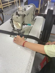 Detailed close-up of a black men's casual belt during the sewing process in a factory