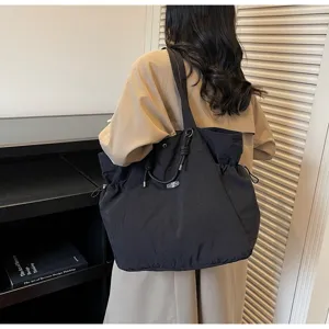 Minimalist large capacity waterproof black tote bag for travel, work and daily commute