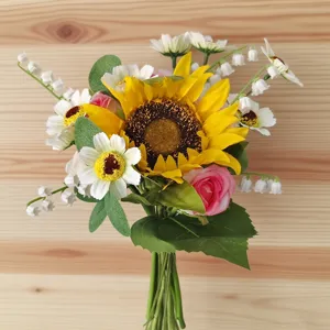 Primer plano de ramo de flores artificiales con girasol y rosas para decoración.