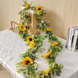 Artificial sunflower and eucalyptus garland detail showing lush leaves and bright blooms.