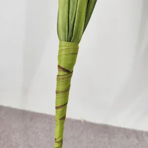 Macro view of textured artificial onion grass stem with green and brown wrapping.