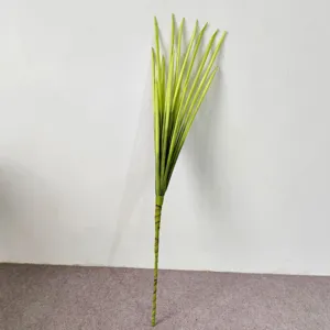 Detailed macro view of artificial green PE long-leaf scallion grass plant for home decor