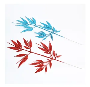 Close-up detail of glitter artificial bamboo leaves decoration, shiny festival branch.