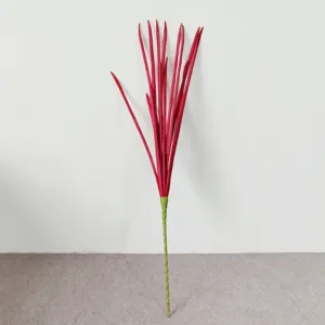Detail view of a single long red PE faux pin-onion grass stem for home decoration