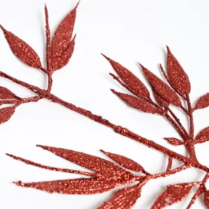 Red glitter artificial leaves for Christmas tree decoration and festive holiday home decor.