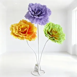 Detail view of giant artificial peony flower props in a clean white room scene setup.