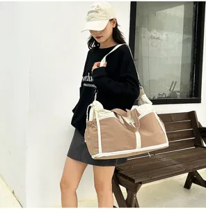 Large capacity travel duffel bag for gym and sports shown being worn by a model.