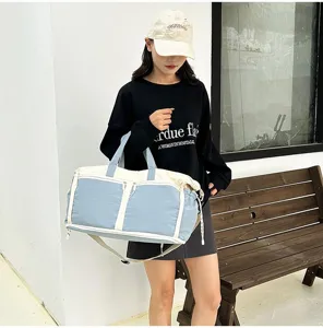 Large blue and white multifunctional travel bag shown in use by a model outdoors