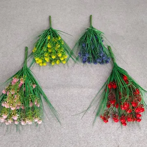 Detailed shot of multi-color artificial flower bunches with green grass leaves for decor.