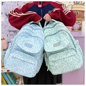 Large capacity leopard print backpack in light blue and green for school or travel.