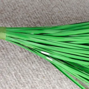 Artificial onion grass detail shot, green plastic grass bundle for home wedding decor, realistic plant.