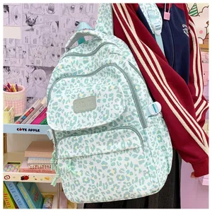 Mint green leopard print backpack for students, featuring a large capacity and multi-pocket design.
