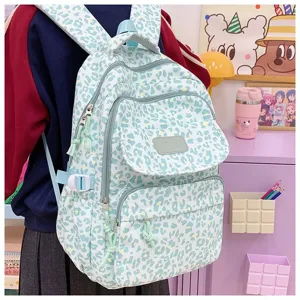 Mint green leopard print backpack worn by a student in a casual cozy school setting