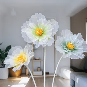 Gros plan de grandes fleurs artificielles en filet avec des pétaux délicats et des étamines jaunes.