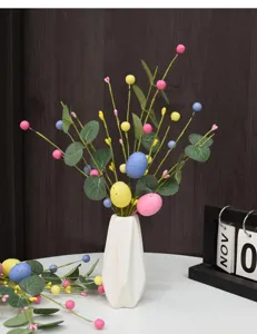 Detailed view of colorful Easter egg berry picks with eucalyptus leaves in a vase