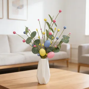Decorative Easter egg picks with eucalyptus leaves and colorful berries in a white vase