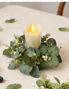Detailed close-up of artificial eucalyptus leaf candle ring for festive home table decor