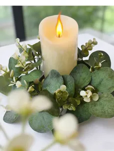 Detailed view of artificial eucalyptus leaf candle wreath for home table decoration