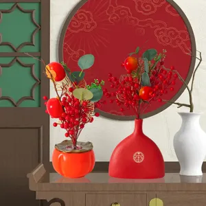 Detailed view of Chinese New Year festive red berry floral arrangements in red vases