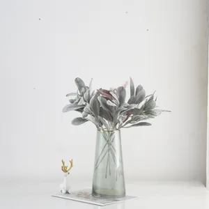 Details of artificial flocked rabbit ear leaves bouquet in clear glass vase for home decor