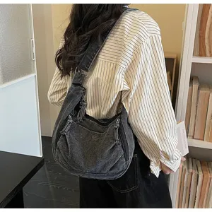 A model wearing a stylish vintage grey large capacity denim hobo bag in a library setting
