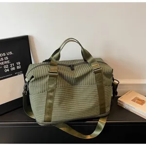 Green checkered large capacity duffel bag with shoulder strap for travel and gym use.