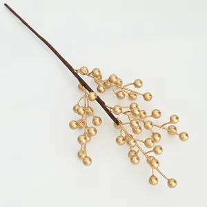 Close-up detail shot of artificial golden berry branch for floral arrangement decor.