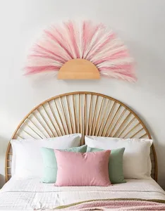 Detail view of the pink and white artificial pampas grass wall hanging decor for home cozy room.