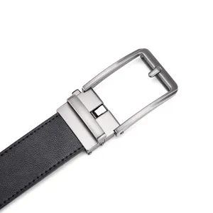 Close-up macro view of brushed silver automatic buckle on black leather belt detail