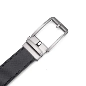 Macro close-up of gunmetal buckle and textured black leather belt strap for men