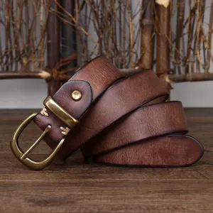 Macro view of 3.3cm vintage distressed brown leather belt with antique brass pin buckle