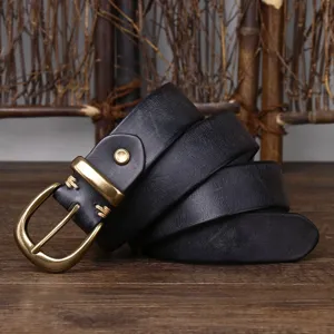 Detail shot of vintage black leather belt with distressed brass pin buckle texture.