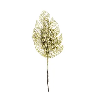 Gold glitter monstera leaf christmas decoration branch detail closeup party photography props