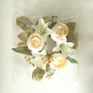 Detail shot of artificial lily and rose candle ring, perfect for romantic home and wedding decor.