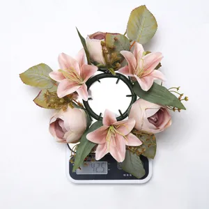 Detailed view of artificial lily candle ring floral wreath table centerpiece for home decor.