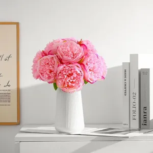 Artificial peony flowers bouquet with white ceramic vase for home wedding decor and table centerpiece.