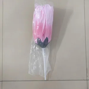 Close up detail of giant artificial pink rose flower bud for wedding aisle and event decor.