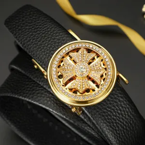 Close-up of luxury gold automatic buckle with rhinestones on black leather belt strap