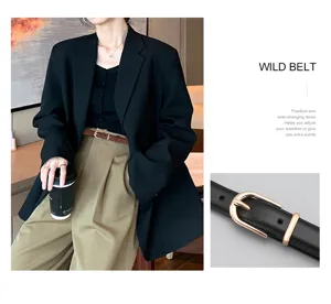 Detailed view of a slim black leather belt for women with an elegant gold buckle