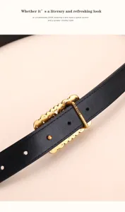 Detailed macro view of women's vintage black leather belt featuring an ornate brass buckle