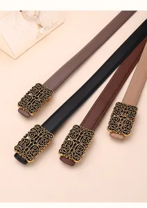 Close-up of vintage women's skinny belts with ornate filigree buckles in four colors