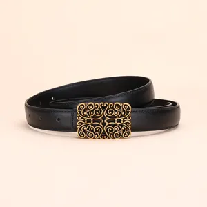 Vintage black women's belt with an ornate gold filigree scroll buckle for elegant styling.