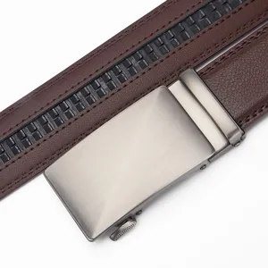 Macro view of men's genuine brown leather belt with brushed silver automatic buckle