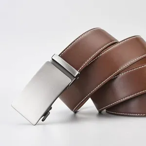 Macro detail of a premium brown leather belt featuring a silver brushed automatic buckle