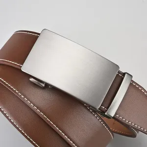 Detail view of men's brown leather belt with brushed silver automatic buckle