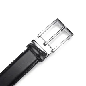 Close-up detail of black leather belt featuring a sleek silver metal pin buckle design