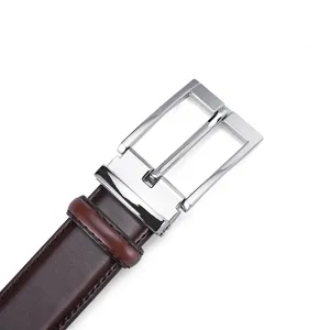 Close-up of men's leather belt with classic silver pin buckle and smooth brown finish