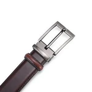 Close-up of men's leather belt with gunmetal pin buckle and smooth finish