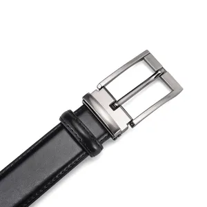 Detail of a men's black leather belt featuring a gunmetal pin buckle and stitched edges