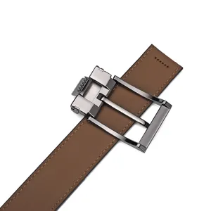 Detailed close-up of a men's brown leather belt with a sleek gunmetal pin buckle.